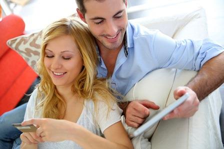 Young couple with a tablet and a credit card